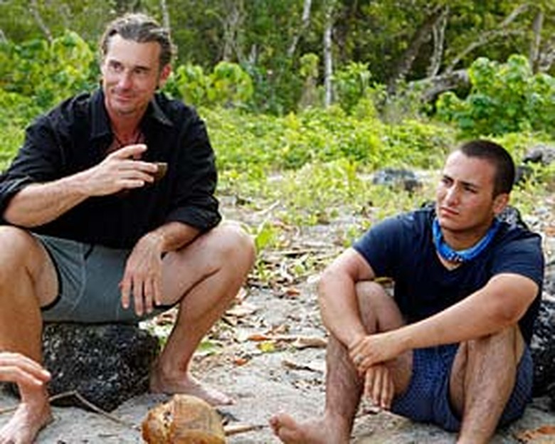 Coach and Brandon sitting by the fire during the pre-merge